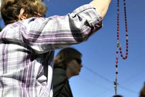 Jane Petersen holds her rosary in prayer with other pro-life activists in front of Planned Parenthood in Kalamazoo, Mich., on Aug. 22. Demonstrations at Planned Parenthood facilities were held across the country; Below, photos from the other protests in the U.S.