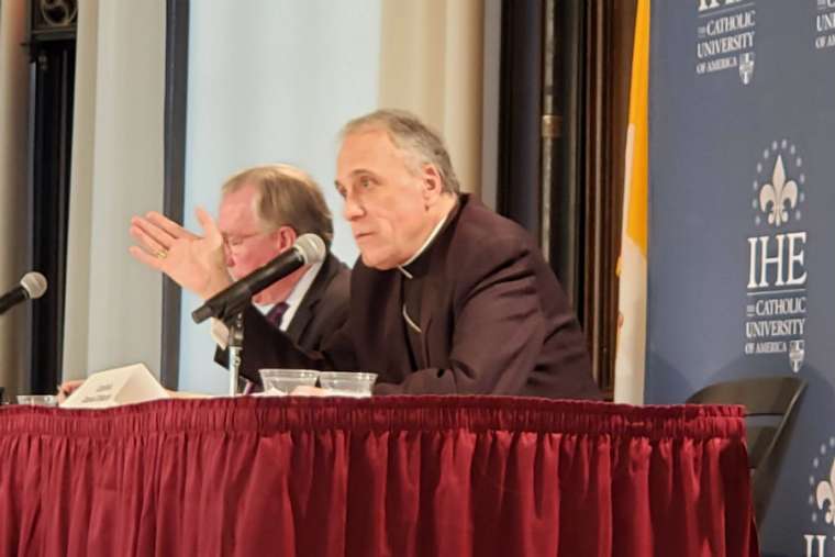 Cardinal Daniel DiNadro and Catholic University president John Garvey participate at the CUA conference Feb. 6. 