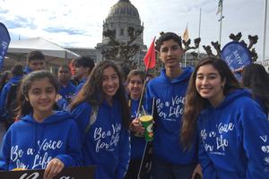 Above, teens attend the Walk for Life West Coast 2020 with Vox Vitae; below, Father Frank Pavone of Priests for Life and students from St. Joseph Academy pose for a photo in front of the San Francisco cathedral. Also below: Liz from Our Lady of Peace parish, along with her family, attends the walk, and seminarians from St. Patrick’s Seminary show their support for life. Bottom of page: Yoselin Donas, r, and her family attend the 16th-annual pro-life event.