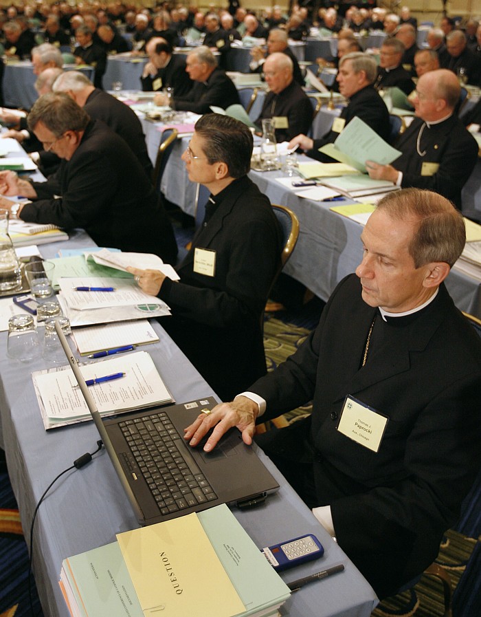 Auxiliary Bishop Thomas J. Paprocki of Chicago works on his laptop computer during the U.S. bishops' general meeting in Baltimore Nov. 17, 2009.