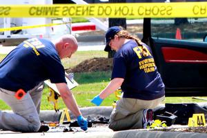 Investigators work a crime scene outside of the Curtis Culwell Center after a shooting occurred the day before May 4 in Garland, Texas.