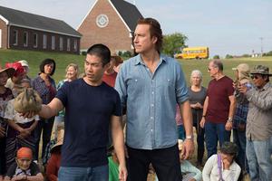 Ye Win (Nelson Lee) and Rev. Michael Spurlock (John Corbett) work together for the good of community and faith.