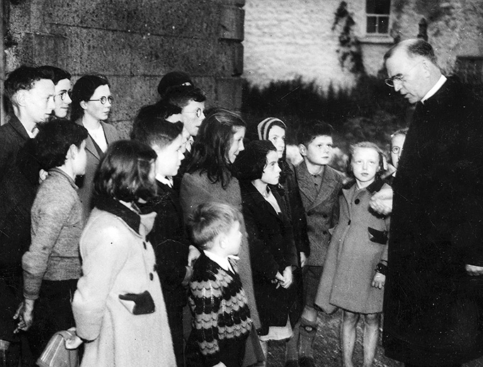 Father Flanagan talking with children in his hometown of Ballymoe, Ireland, in 1946.
