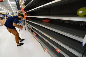 A Walmart employee stocks Gatorade on an empty shelf on August 29, 2019 in Orlando, Florida. People throughout the Bahamas, Florida, Georgia and the Carolinas are preparing for Hurricane Dorian to hit beginning Sunday.