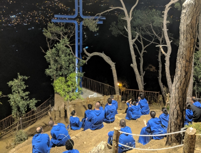 Brothers and sisters from the religious order Mission of Life pray at the cross, the final station of the Way of Life hiking path at the order's Village of Peace in Mashraa, Lebanon, which is on a hillside. Below: A sculpture of Jesus in the Garden of Gethsemane in the Way of Life hiking path was created by sculptor Nayef Alwan. Also shown: Lebanese Cardinal Bechara Rai, patriarch of Maronite Catholics (left), hikes the Way of Life path with Father Wissam Maalouf, founder of the Mission of Life religious order, as youth involved in Youth of Life participate in a July camp.