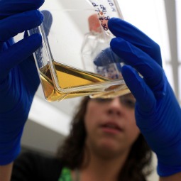 Kristin Martins-Taylor holds up a container with stem cells at the University of Connecticut`s (UConn) Stem Cell Institute at the UConn Health Center in 2010.