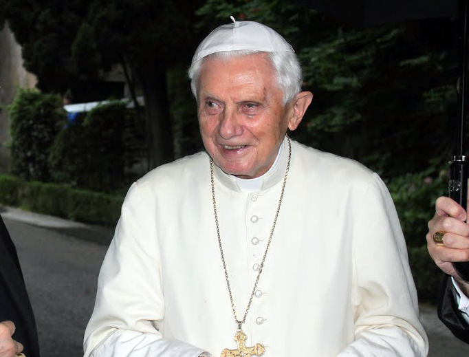 In this 2015 file photo, Pope Emeritus Benedict XVI meets with seminarians from the Diocese of Faensa-Modigliana, Italy, in the Vatican Gardens. 