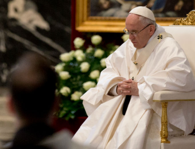 Pope Francis prays during Mass on his visit to Chile, 2019. 