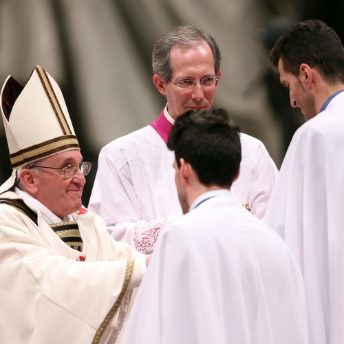 Pope Francis welcomes two catechumens at the Easter
vigil Mass at St. Peter’s Basilica last year. 