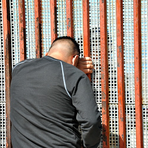 Families meet through a fence on the U.S.-Mexico border.