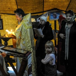 Protesters pray for peace in one of two tent-chapels at Kiev's Maidan Square. 