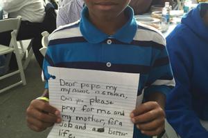 Steven Waller holds up the letter he planned to give to Pope Francis. The Pope received the letter and entrusted it to one of his entourage.