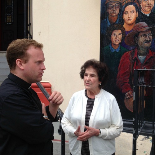 Father Mark Doherty speaks with parishioners outside the rectory of St. Peter Church in San Francisco.
