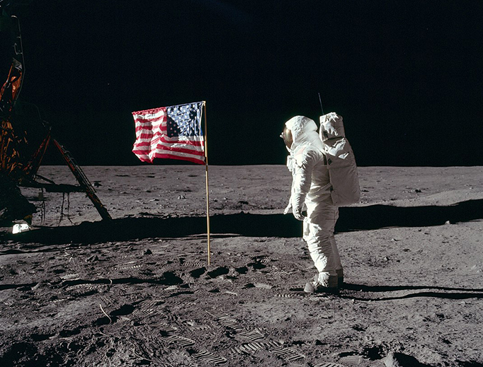 Buzz Aldrin salutes the U.S flag on the moon July 19, 1969. His fingertips are visible on the far side of his faceplate.