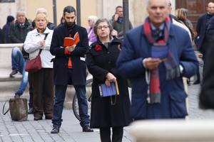 A protester reads a devotional book alongside others taking part in the 'break the silence' demonstration in Rome, Feb. 19; top to bottom: scenes from the demonstration, press conference.