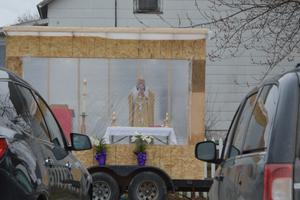 Father Michael Klos celebrates a drive-in Mass on Easter Sunday 2020 in the Sacred Heart Church parking lot in Cashton, Wisconsin. 