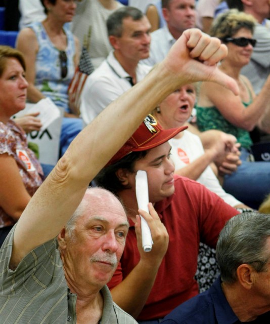 A man gives the thumbs-down sign at an Aug. 25 health-care town hall in Reston, Va.