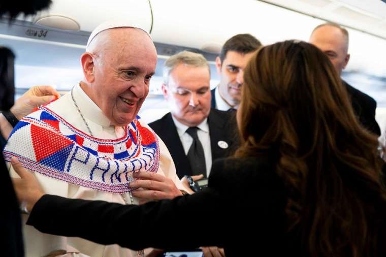 Pope Francis receives a gift aboard the papal plane to Panama Jan. 23. 