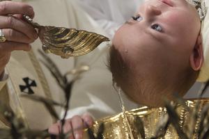 Pope Francis baptizes an infant in the Sistine Chapel on the feast of the Baptism of the Lord on Jan. 10, 2016.