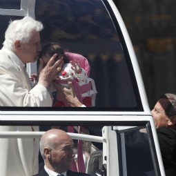 Pope Benedict XVI kisses a baby as he leaves his general audience in St. Peter&#8217;s Square at the Vatican April 13. 