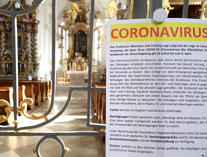 A sign at the entrance of St. Johann Baptist in Aufkirchen near Erding, Germany, explains the temporary ban on public Mass as a precaution against the coronavirus on March 15, 2020.