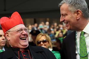 New York Mayor Bill de Blasio pauses with Cardinal Timothy Dolan as he marches in the annual St. Patrick's Day parade on March 17, 2016, in New York City.
