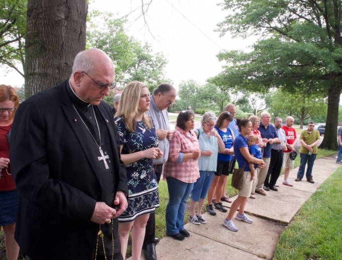 Archbishop Joseph Naumann leads the Rosary in front of Planned Parenthood in Overland Park, Kansas, praying along with archdiocesan pro-life coordinator Allison Donohue (in patterned navy dress) and others. 