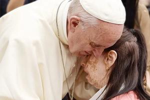 Francis gives a hug May 18.