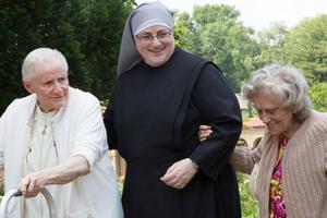 Sister Constance Veit (shown above) and other sisters interact with their dear residents in happier times; the Little Sisters of the Poor continue to provide care and fellowship according to mandated guidelines in this time of coronavirus pandemic.