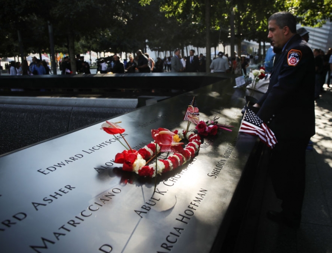 A New York City firefighter observes a moment of silence during ceremonies at the National September 11 Memorial on Sept. 11, 2019, in New York City. Throughout the country services are being held to remember the 2,977 people who were killed in New York, the Pentagon and in a field in rural Pennsylvania.
