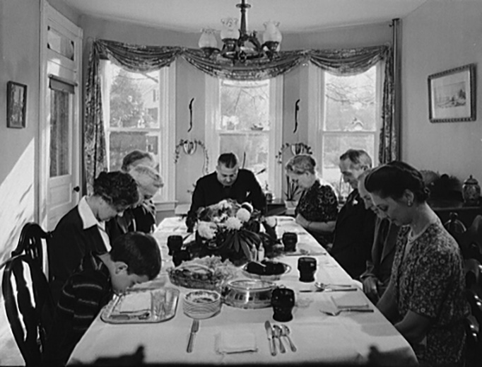 Saying grace before carving the turkey at Thanksgiving dinner in the home of Earle Landis in Neffsville, Pennsylvania, in November 1942.