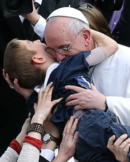 Pope Francis embraces a boy prior to his first 'Urbi et Orbi' blessing on Easter Sunday, March 31.