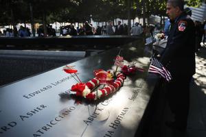 A New York City firefighter observes a moment of silence during ceremonies at the National September 11 Memorial on Sept. 11, 2019, in New York City. Throughout the country services are being held to remember the 2,977 people who were killed in New York, the Pentagon and in a field in rural Pennsylvania.

