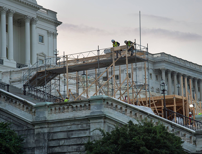 Construction crews prepare the platform at the U.S. Capitol for Donald J. Trump's inauguration on Jan. 20, 2017.