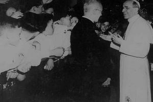 Pope Pius XII greets pilgrims during a general audience in St. Peter’s Basilica. 