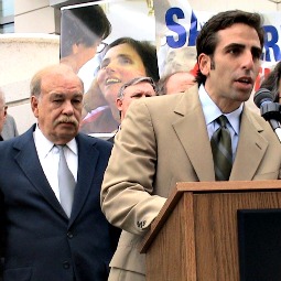 Bobby Schindler, with his father and a photo of his sister behind him, speaks at a rally.