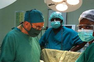 Father Aldo Marchesini operates on a patient in Mozambique.