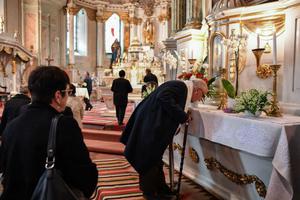 Members of Romanian-Hungarian community pray May 21 inside the Franciscan church in Miercurea Ciuc city, next to the Marian Shrine of Şumuleu Ciuc, the place of the papal outdoor Mass this weekend. Francis goes to Romania May 31 for three days, carrying a message of concord in this Orthodox country where the Greek Catholic minority is still struggling to recover from the suffering endured during the communist period. This journey under the motto ‘Let’s Walk Together!’ comes 20 years after the visit of John Paul II: The first pope hosted in Romania, he was also the first to visit a large Orthodox country since the schism of 1054 between Rome and Byzantium. 