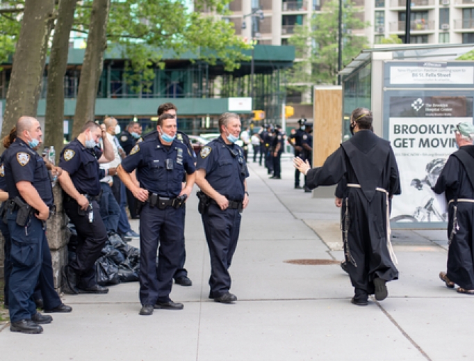 Priests pass a group of NYPD officers during a Black Lives Matter protest in Manhattan on June 4, 2020. 