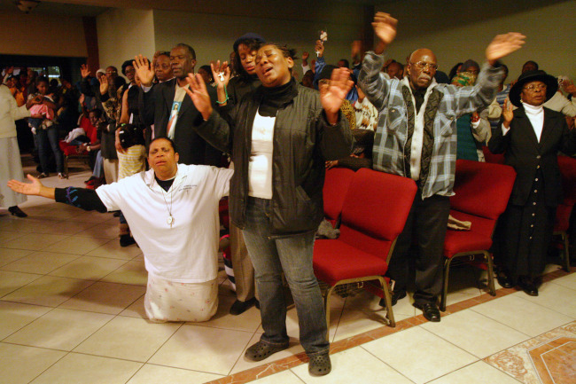 Haitians pray during a memorial service at Notre Dame D'Haiti Church in Miami Jan. 13. During the service, Father Reginald Jean-Mary, pastor, said the Jan. 12 earthquake that hit Haiti was the darkest moment in that country's history.