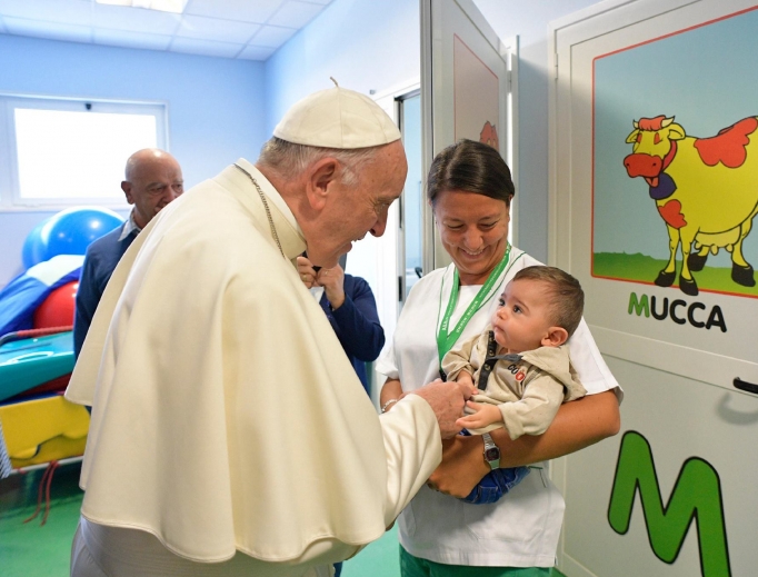 Pope Francis visits a little patient at the Santa Lucia Foundation neuro-rehabilitation center in Rome Sept. 22. 