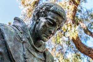 Bowed head of statue of Father Junipero Serra at the Serra Mission Museum, the former site of a fort and the first European settlement on the Pacific Coast.