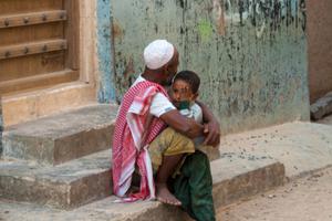 A little boy cries in the arms of his father, Shibam, Yemen, 2007.