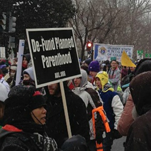 A pro-life supporter holds a Defund Planned Parenthood sign at the March for Life on Jan. 25, 2012.

