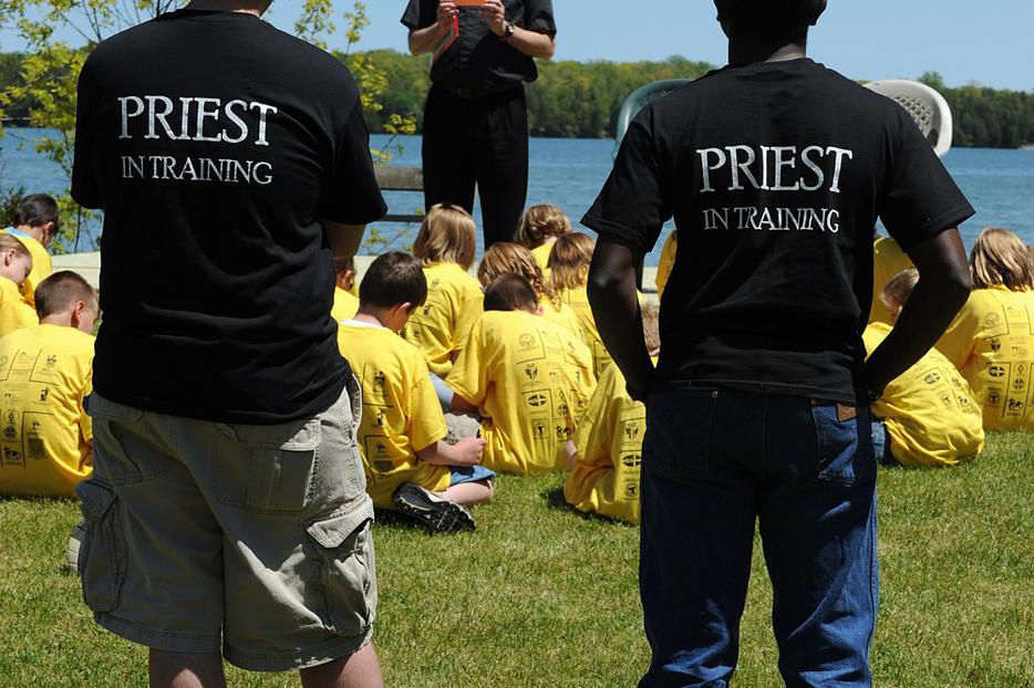 Seminarians Patrick La Pacz and Alvan Amadi listen as Father Tom Long addresses youths gathered at St. Joseph Retreat House in Bailey's Harbor, Wis., during a retreat focusing on Catholic vocations in 2009.