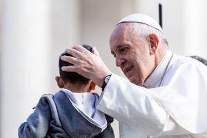 Pope Francis blesses a child during his Wednesday General Audience on May 1, 2019. 