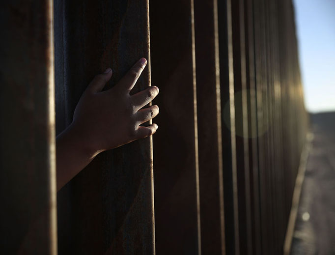 A child reaches through from the Mexican side of the U.S./Mexico border fence on June 24, 2018, in Sunland Park, New Mexico.