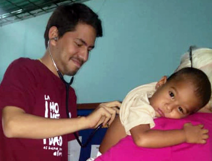 Dr. Lenin Mejías Peña checks up on a young patient in Venezuela.