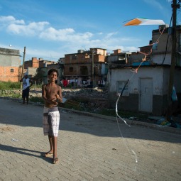 A boy flies a kite July 19 in the Rio de Janeiro shanty town of Varginha, which Pope Francis visited July 25.