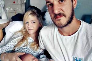 Chris Gard and Connie Yates hold their son.